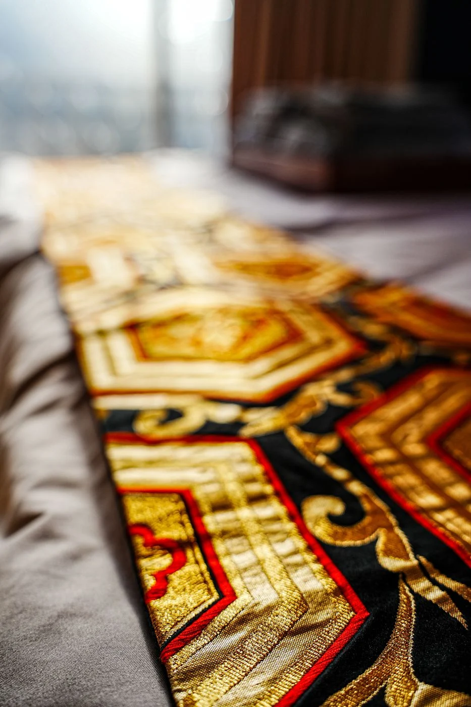A gold obi runner on the bed